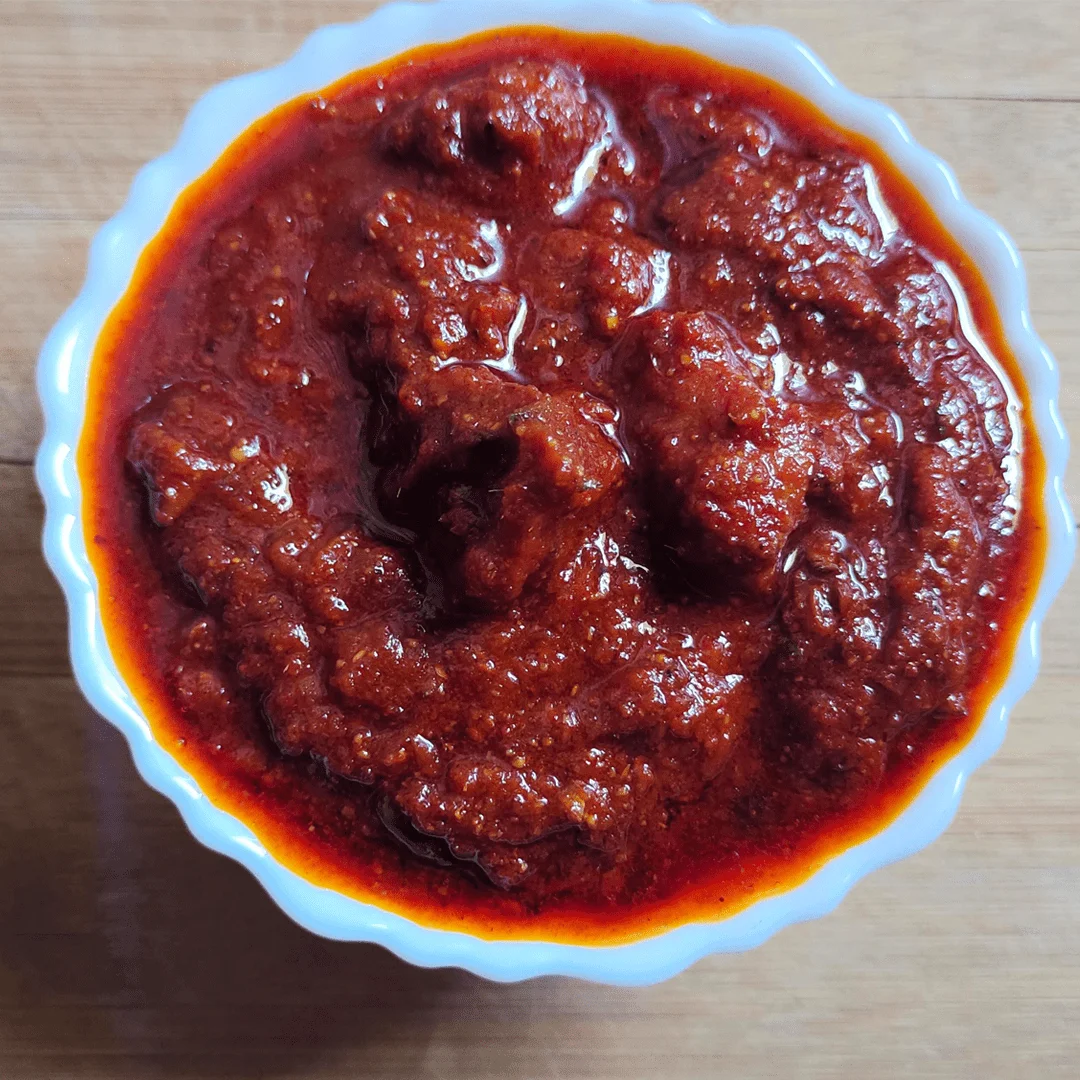 Spicy and flavorful homemade chicken boneless pickle made with tender chicken and aromatic spices from FoodFida.com. Perfect with rice, roti & parathas.
