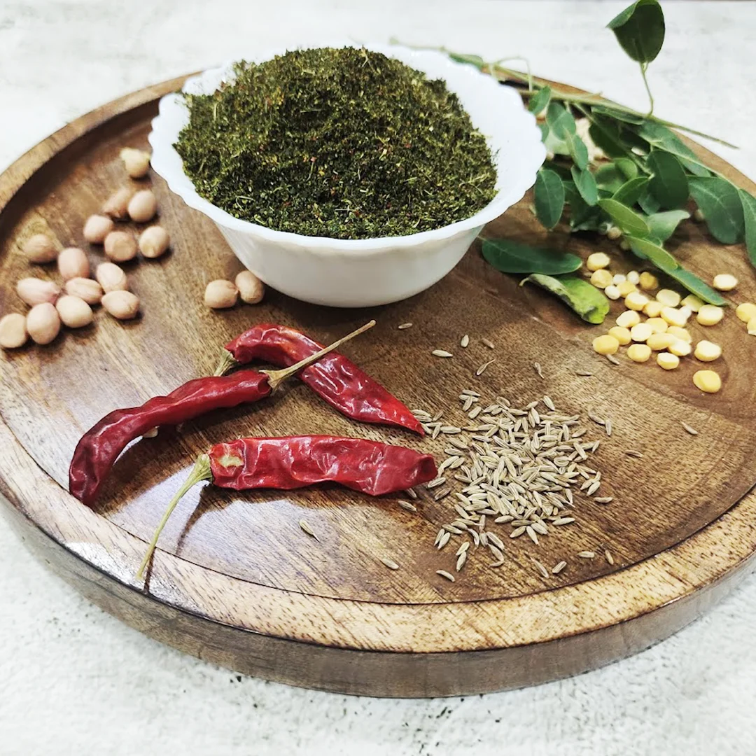 Fresh moringa leaves drying naturally for homemade moringa powder.